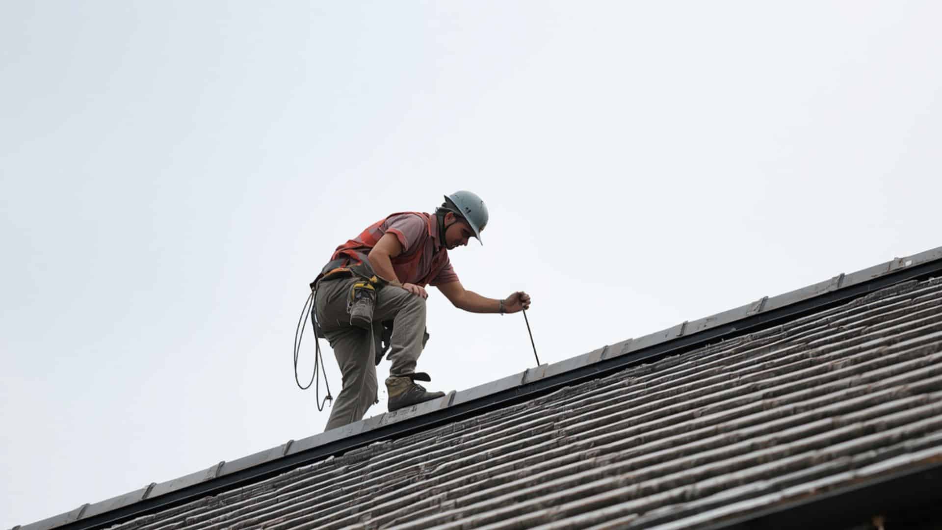 construction worker inspecting a building roof